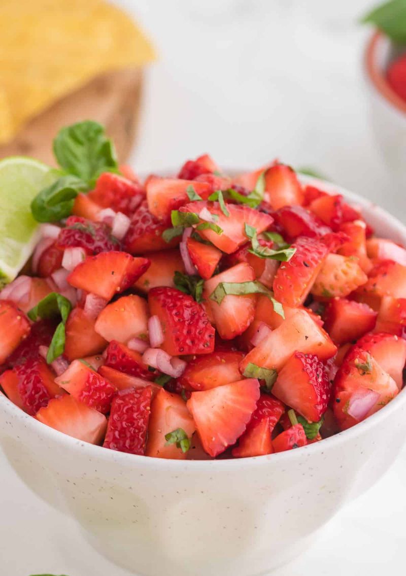 Classic fresh strawberry salsa with strawberries, lime, cilantro, and diced cucumber