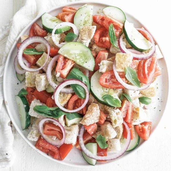 Classic summer panzanella with crusty bread cubes, ripe tomatoes, basil, mozzarella, and a bright vinaigrette