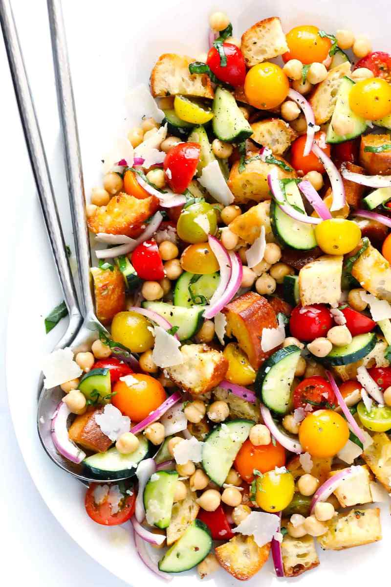 Classic summer panzanella with toasted bread cubes, ripe tomatoes, basil, mozzarella, and a zesty vinaigrette