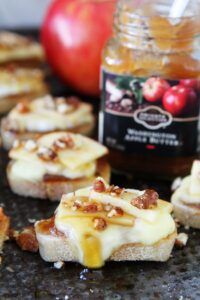 Toasted crostini layered with brie, apple butter, and toasted pecan pieces