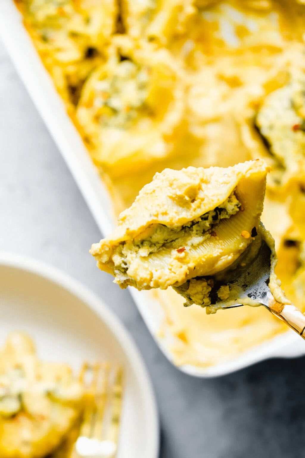 Layers of thin potato slices and leeks in a creamy cheese sauce, baked until golden in a dish.